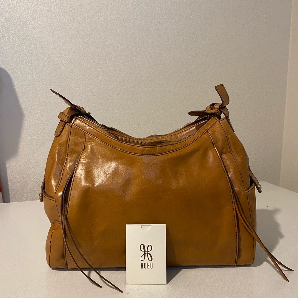 Brand new Hobo! Outside pockets, side pockets inside pocket with Zipper.
